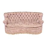 A pink damask button back upholstered kidney shaped sofa, early 20th century, in the manner of