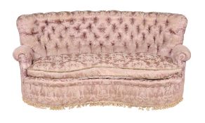 A pink damask button back upholstered kidney shaped sofa, early 20th century, in the manner of