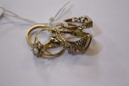 A 9ct gold ring, 9ct gold 'mum' ring, 9ct gold flower ring and three other rings