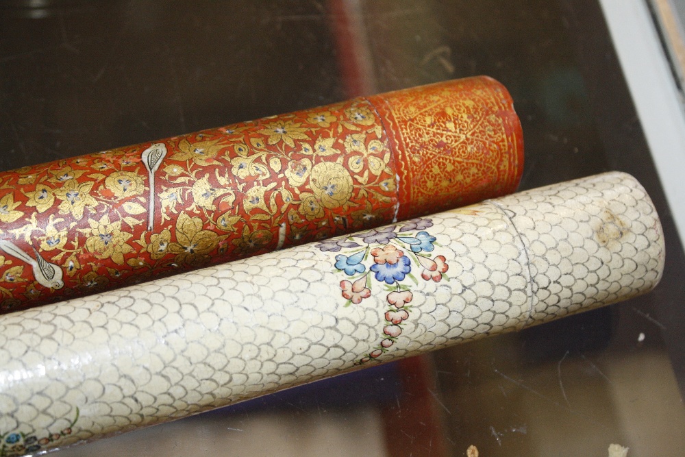 Two lacquered document holders, one cream ground and floral decorated, 39cm long and the other red