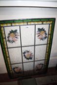 An Aesthetic style stained glass window centred by a lady within a roundel surrounding by ivy 64cm