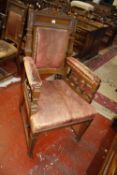 A set of seven Victorian oak and leather upholstered chairs to include one armchair