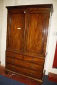 A 19th century mahogany linen press with a pair of panel doors enclosing linen slides, above two