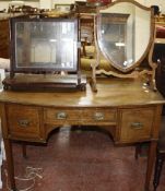 A mahogany kneehole bowfront dressing table 107cm wide and two mahogany toilet mirrors