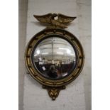 A Regency style gilt convex mirror with eagle cresting 70cm high, 47cm wide