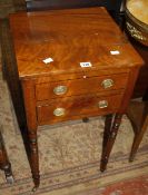 A Regency mahogany and ebony inlaid work table with a hinged lid and one drawer on ring turned