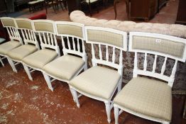 A set of six white painted dining chairs