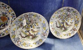A pair of polychrome delft plates, decorated with birds and tree, 31cm in diameter and another delft