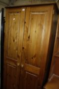 A pine wardrobe 80cm wide and a teak open bookcase with lower panelled cupboard 103cm wide