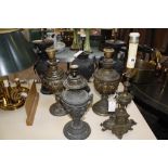 Seven metal lamps, including three Chinese-style vases adapted for lights.