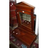 An Empire style mahogany toilet mirror with an arched pediment and bevelled plated flanked by