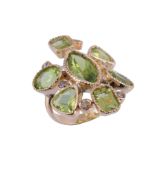 A peridot ring,   the central marquise shaped peridot in a cut down collet setting within a