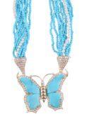 A turquoise and diamond butterfly pendant,   the butterfly with carved turquoise wings within a