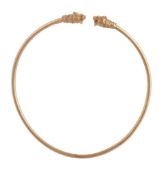 A gold torc necklace,   the hollow band set with a lion's head to each terminal, the eyes and head