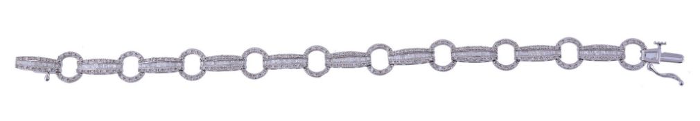 A diamond bracelet,   the bracelet with alternating tonneau shaped panels set with baguette and