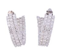 A pair of diamond hoop earrings, the curved panels set with brilliant cut...  A pair of diamond hoop
