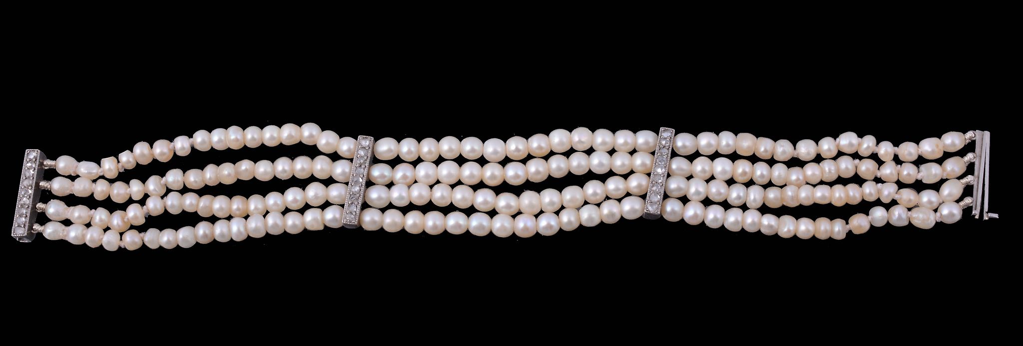 A natural pearl and diamond bracelet, composed of four strands of graduating...  A natural pearl and