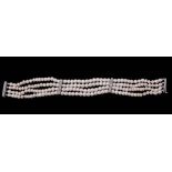 A natural pearl and diamond bracelet, composed of four strands of graduating...  A natural pearl and