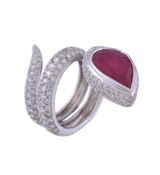 A ruby and diamond snake ring, the coiled snake set with brilliant cut diamonds  A ruby and