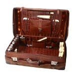 An early 20th century crocodile skin suitcase with silver fittings mainly by...  An early 20th