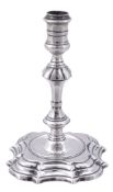 A George II cast silver taperstick by James Gould, London 1740  A George II cast silver taperstick
