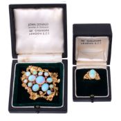 An 18 carat gold opal and ruby brooch by John Donald  An 18 carat gold opal and ruby brooch by