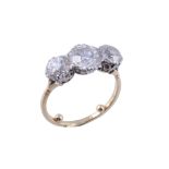 A three stone diamond ring , the central old brilliant cut diamond, weighing 1  A three stone