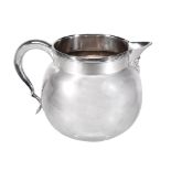 A silver sparrow beak oversized milk jug by Asprey & Co  A silver sparrow beak oversized milk jug by