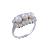 A pearl and diamond ring, the three pearls within a surround of brilliant... A pearl and diamond