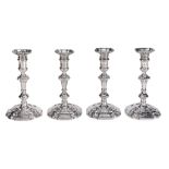 A set of four early George II cast silver shaped square candlesticks by...  A set of four early
