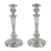 A pair of late George III silver circular candlesticks by John Law  A pair of late George III silver