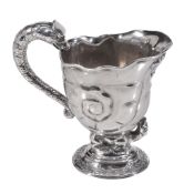 A George II silver cream jug, unmarked, circa 1725, shell-shaped  A George II silver cream jug,