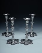 A matched set of four late George II cast silver hexafoil candlesticks by... A matched set of four