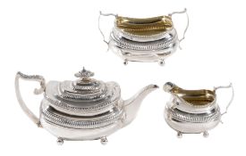 A late George III silver oblong baluster three piece tea service by Solomon...  A late George III