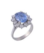 A sapphire and diamond cluster ring , the oval cut sapphire estimated to...  A sapphire and