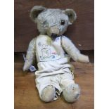 An early/ mid 20th Century teddy bear  , in homemade outfit (af)