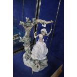 A Lladro figure of a girl swinging from a tree  , 38cm high (af)