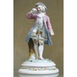 A 20th Century porcelain figure of a man in a pink frock coat   (damaged), 18cm high, a