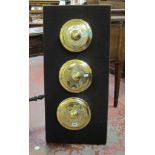Three Indonesian brass gamelan gongs mounted onto a board