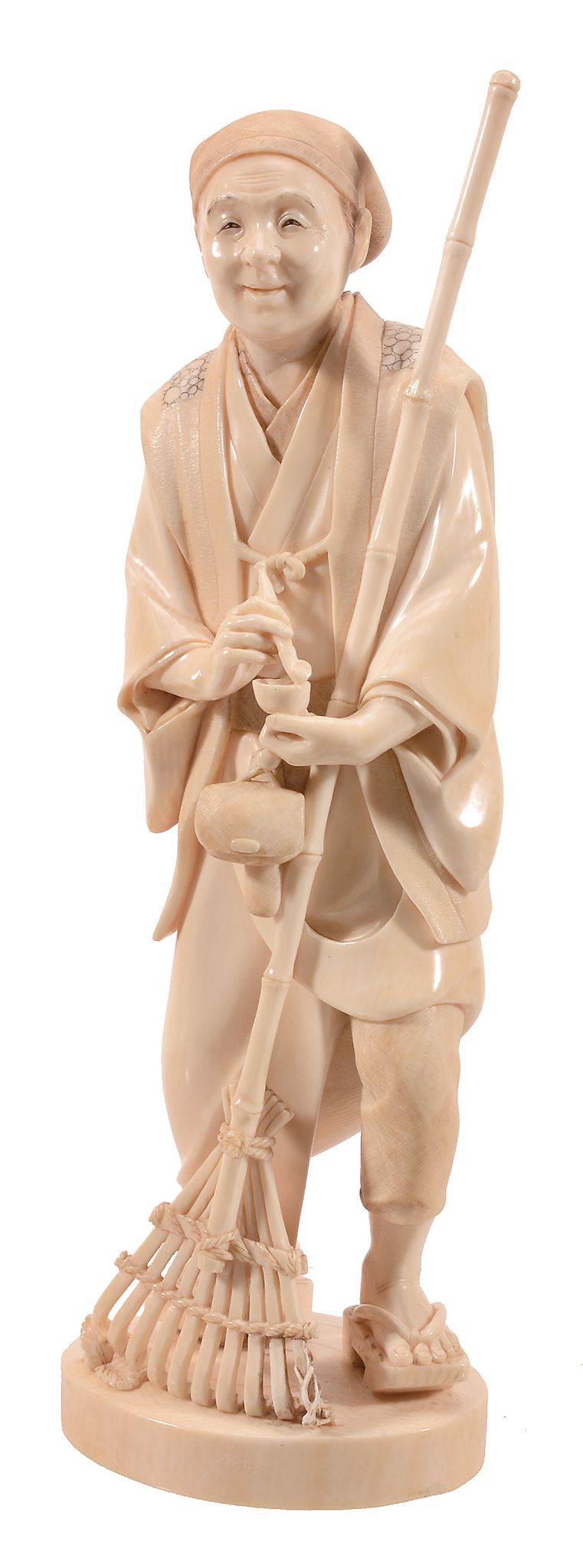 An Ivory Okimono of a Gardener, the figure wearing a short robe over hakama An Ivory Okimono of a