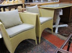 A woven cane effect table and two chairs  , a rattan rocking chair and a cane chair.