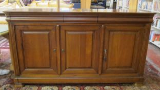 A French design cherry wood finished sideboard   with three moulded drawers over three panelled