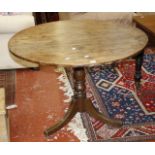 A 19th Century oak tilt top table   on splayed legs 103cm diameter