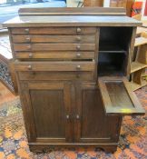 An early 20th Century dentist cabinet   with graduated drawers over a cupboard.