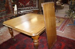 A Victorian mahogany dining table   with one additional leaf, with a moulded top of turned shaped