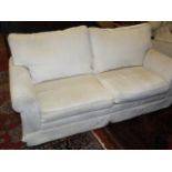 A cream upholstered two seater sofa