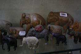 A collection of wooden and other elephants and two Indian daggers