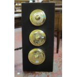 Three Indonesian brass gamelan gongs   mounted onto a board