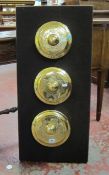 Three Indonesian brass gamelan gongs   mounted onto a board