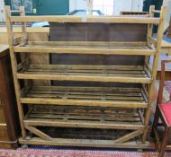 An early 20th Century Bakers Trolley, oak    with six slatted shelves raised on castors.122cm wide